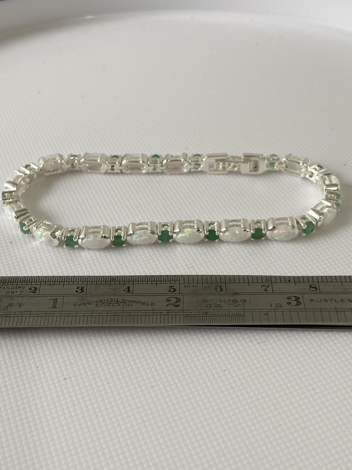 A Silver opal and emerald line bracelet [18.5cm in length]