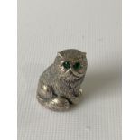 A silver figure of a cat with emerald eyes. [2.3CM IN HEIGHT]