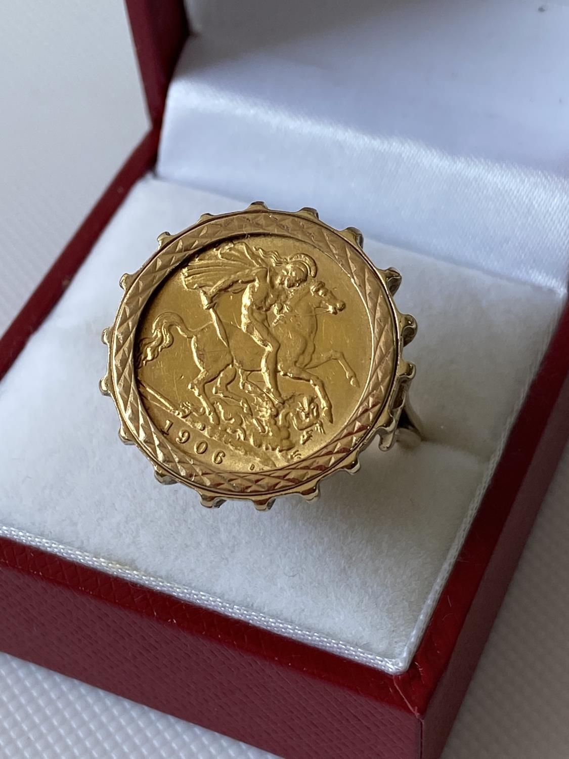 A 9ct gold ring set with a gold half sovereign, dated 1906 [size M] [9.51g]