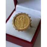 A 9ct gold ring set with a gold half sovereign, dated 1906 [size M] [9.51g]