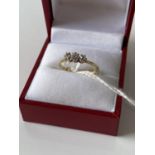 A 9ct gold ring set with 3 diamonds [1.73g] [size M]