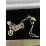 A Silver pendant necklace in the form of an Indian motorcycle. [4.5cm wheel to wheel] [44cm chain]