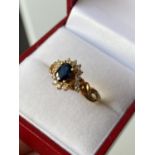 An 18ct gold ladies sapphire & diamond cluster set ring [size L] [3.70g]