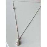An 18ct white gold diamond cluster & single pearl pendant with an 18ct gold necklace [length