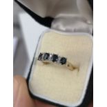 A 9CT GOLD RING SET WITH FOUR SAPPHIRES & DIAMOND CLUSTER. [RING SIZE L] [2.62GRAMS]