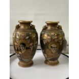 A pair of Japanese satsuma hand painted urn style cases depicting various characters & dragon design