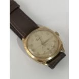 A GENT'S VINTAGE 'EVERITE' 9CT GOLD CASED NON MAGNETIC WATCH, COMES WITH LEATHER STRAP. [NEEDS