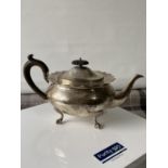 A Birmingham silver teapot supported on claw & ball feet, engraved to the side showing a dragon