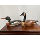 Two large hand carved wooden ducks designed by Jim Harkness. Titled 'Red Breasted Merganser' & '