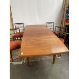 A Retro mid century teak dining table and four matching chairs produced by Vanson. [Table extended