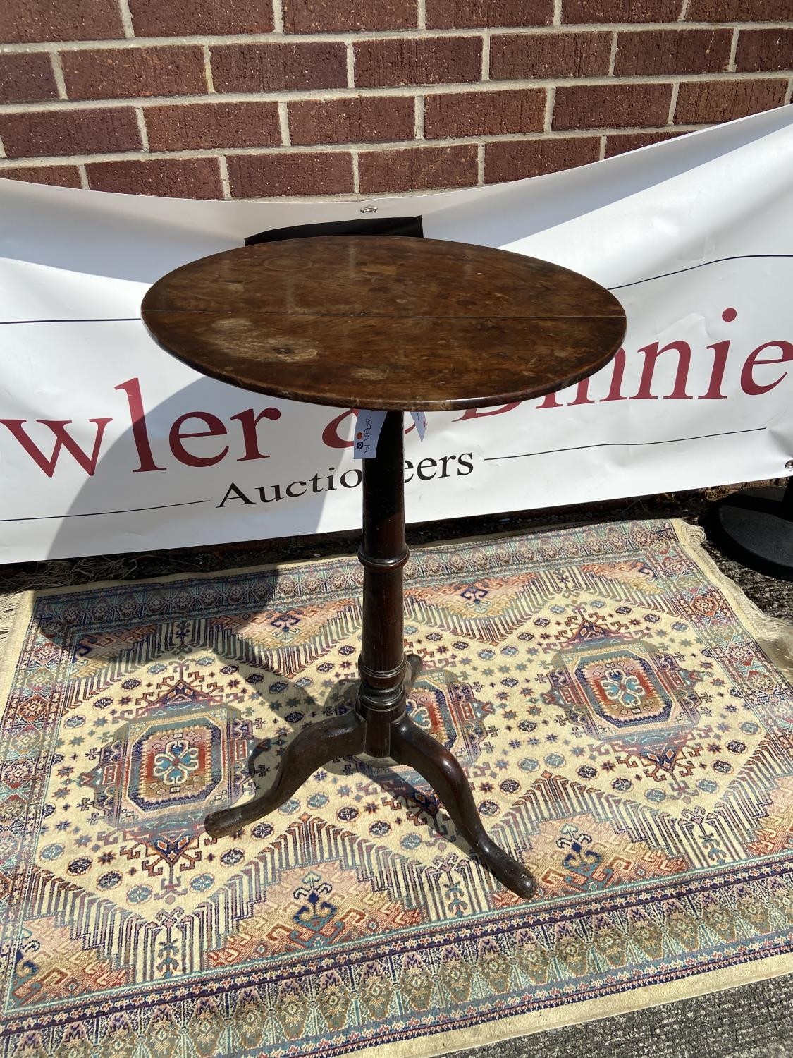Queen Anne walnut candle stand (early 18th century) circular top above a slender ring-turned