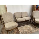 A Vintage Ercol elm wood three piece cottage suite. [two seater 87x130x78cm] [Chairs 89x70x80cm]