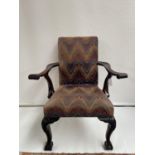 A 19th century carver arm chair, supported on claw and ball feet. [back 95cm] [seat area 47cm]