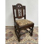 French carved walnut side chair [early 18th century] with a scroll-carved top rail above carved wavy