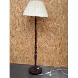 A mahogany free standing lamp, on a circular base, with shade [height with shade, 1.7m]