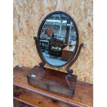 An elegant Victorian oval dressing table mirror, upon a two drawer platform base [height, 59cm,