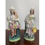 A Pair of Antique Staffordshire Scottish man and lady figurine. Man playing bagpipes and the lady is