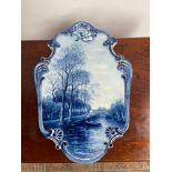 A Large Delft blue and white wall plaque depicting man rowing down a canal scene. Signed J. Du