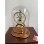 A Reproduction skeleton clock, fitted with a glass dome .In a working condition with key and