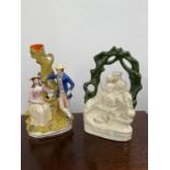 A Lot of two Antique Staffordshire figurines to include Couple resting against a tree and Robbie
