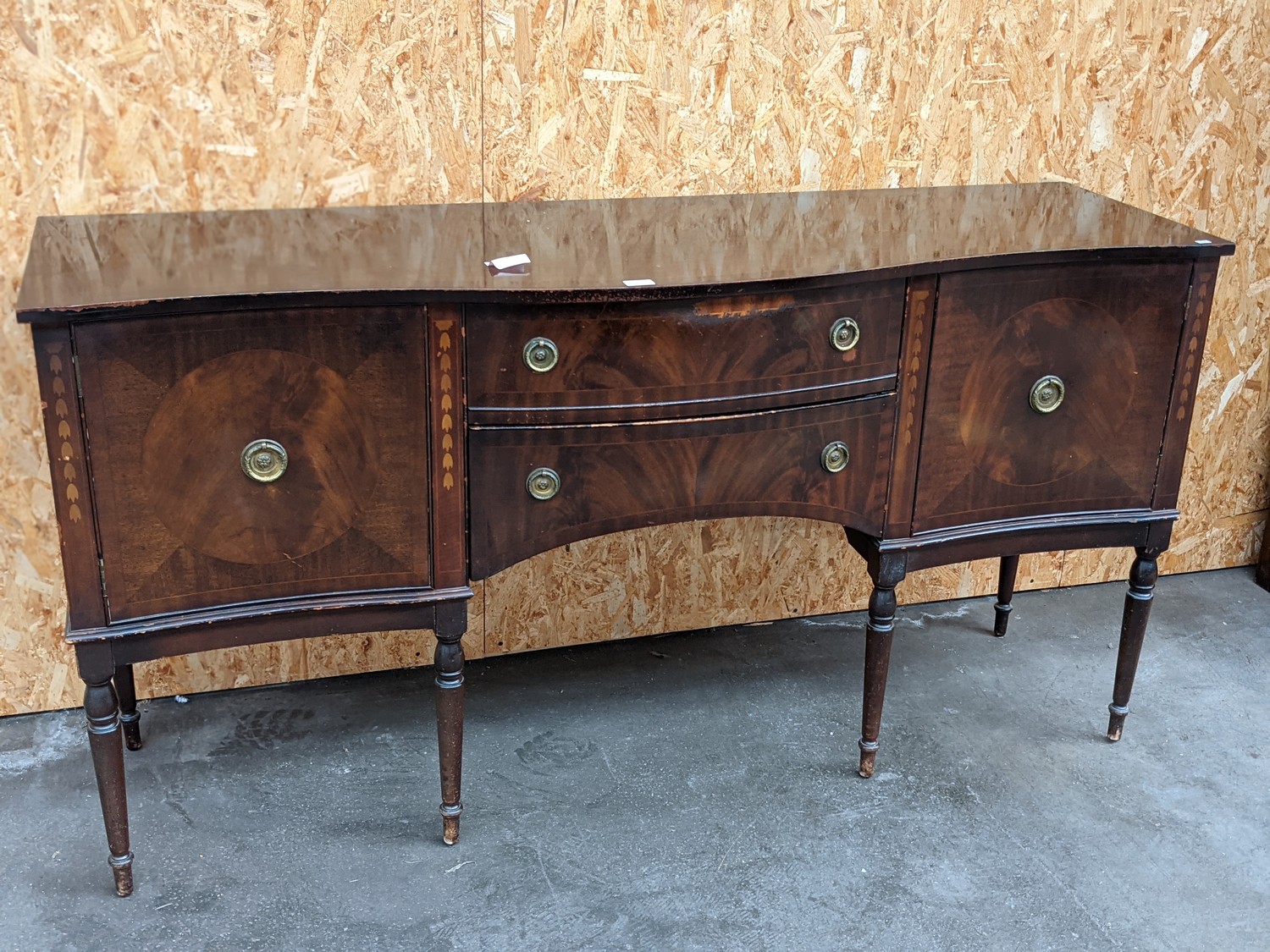 A serpentine bow front 2 door, 2 drawer mahogany unit, upon six turned leg supports [height 88cm,