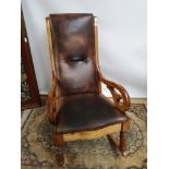 A 19th century rocking chair with curved arms, raised on turned and square legs with applied rocker,