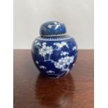 A Chinese blue and white preserve pot with lid, designed with cherry blossoms & double ring