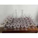 A Large collection of crystal facet cut glasses and decanters. Includes Red and white wine