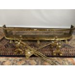 A Victorian gilt brass fire fender, styled with pierced from and claw foot supports, together with a