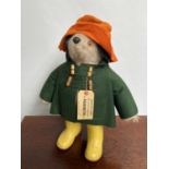 A Vintage Paddington bear with orange hat, green coat and yellow wellies. 50cm in height.