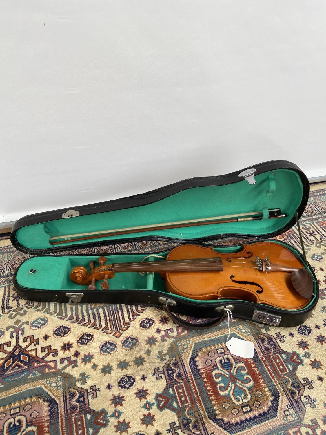 A half size violin, with two bows and travel case
