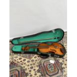 A half size violin, with two bows and travel case