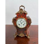 An Antique French Boulle clock. Designed with tortoise shell and brass inlays. Rack French make.