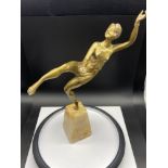 An Art Deco gilt bronze dancing semi nude lady figurine. Displayed upon an alabaster base. Signed