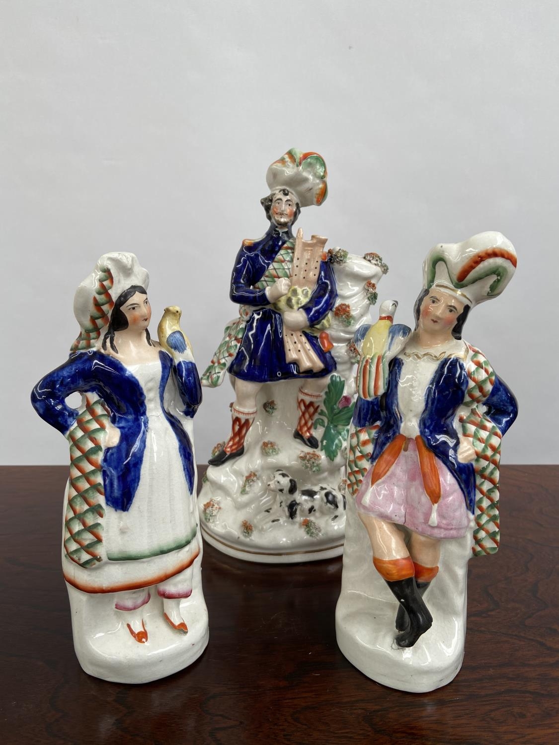 A Lot of three Antique Staffordshire Scottish design figurines. [29cm in height]