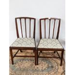 A lot of two Georgian armchairs, with three splat back, supported on tapered legs with a middle