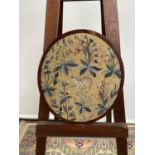 A 19th century oval framed tapestry, depicting a cub amongst foliage [height, 38cm, width 33cm]