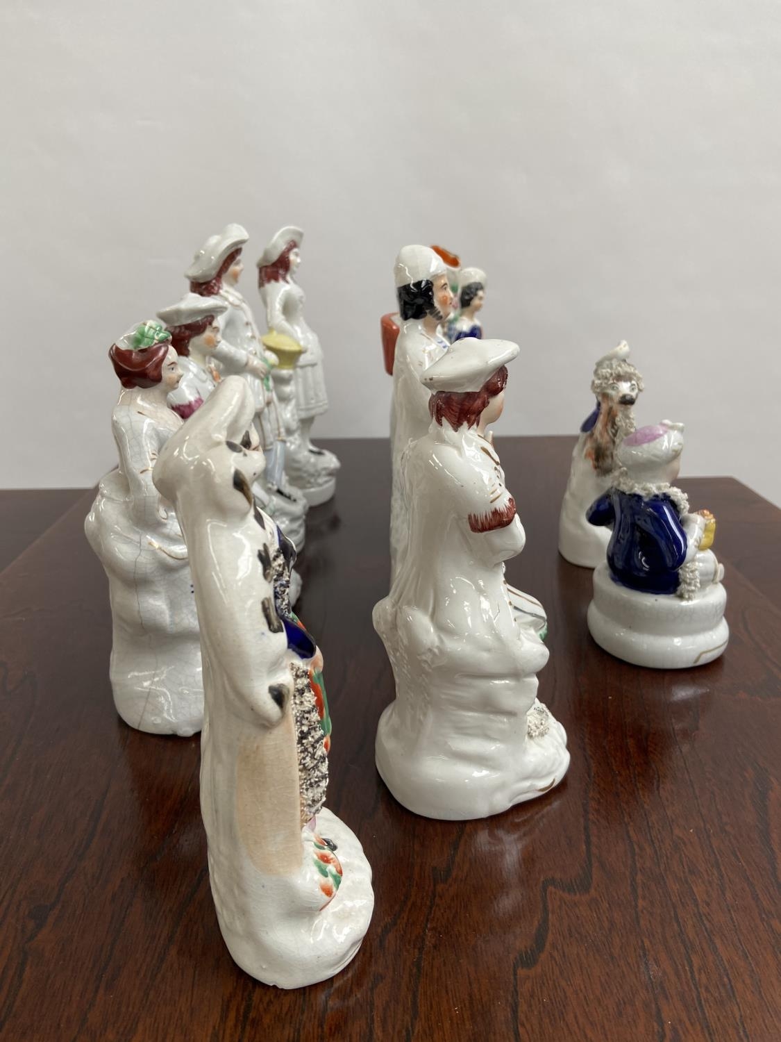 A Collection of antique Staffordshire figurines to include young girl sat upon a rams back, Asian - Image 6 of 9