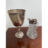 A Large silver plated trophy together with a large cut glass and plated rim claret jug. [35cm in