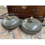 A Pair of antique curling stones fitted with brass and ebony wood handles. Both engraved R.T.
