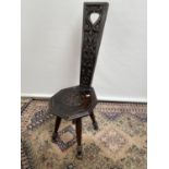 A Vintage Arts and Crafts carved spinning wheel chair.