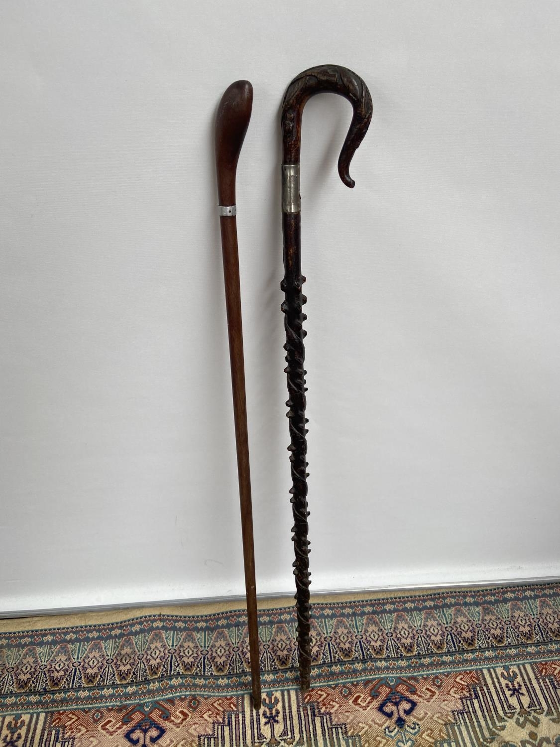 A lot of two antique walking canes, one carved and designed with thistle and snake [longest length