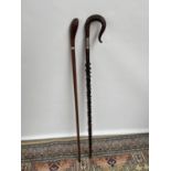 A lot of two antique walking canes, one carved and designed with thistle and snake [longest length