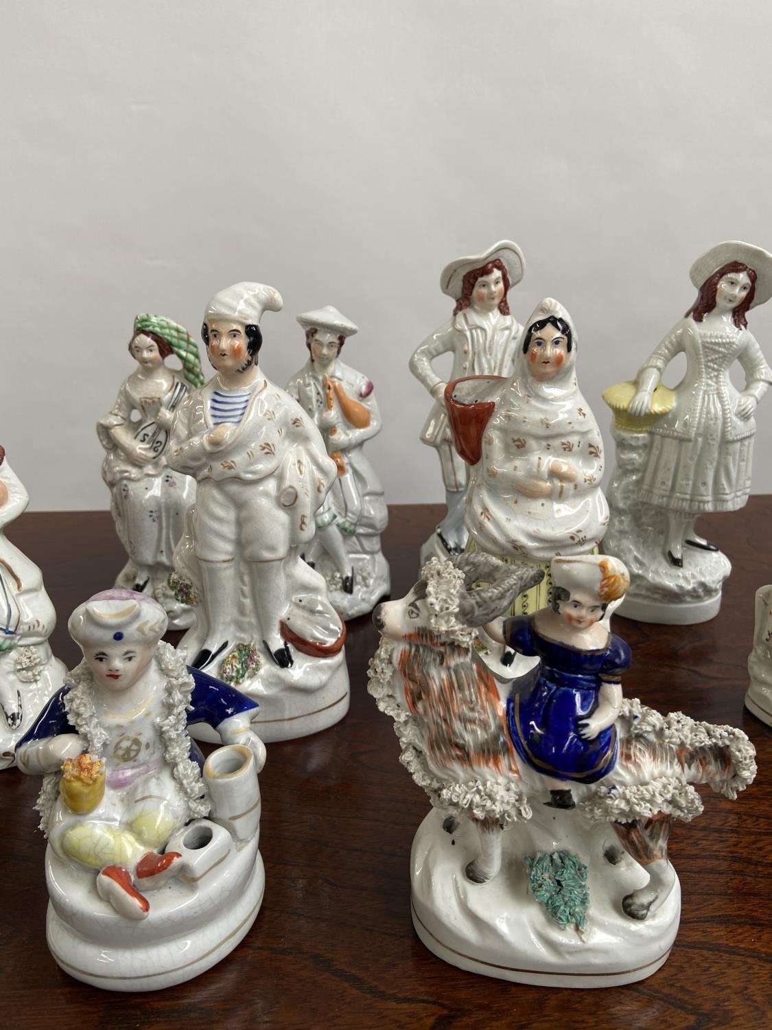 A Collection of antique Staffordshire figurines to include young girl sat upon a rams back, Asian - Image 3 of 9