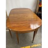 A Georgian/ Victorian mahogany dining table. Consists of two half moon ends and two leaves.