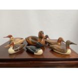 A Collection of hand carved wooden duck decoy sculptures by Jim Harkness.