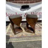 A pair of art deco design side tables, each carved from an individual piece of solid teak [