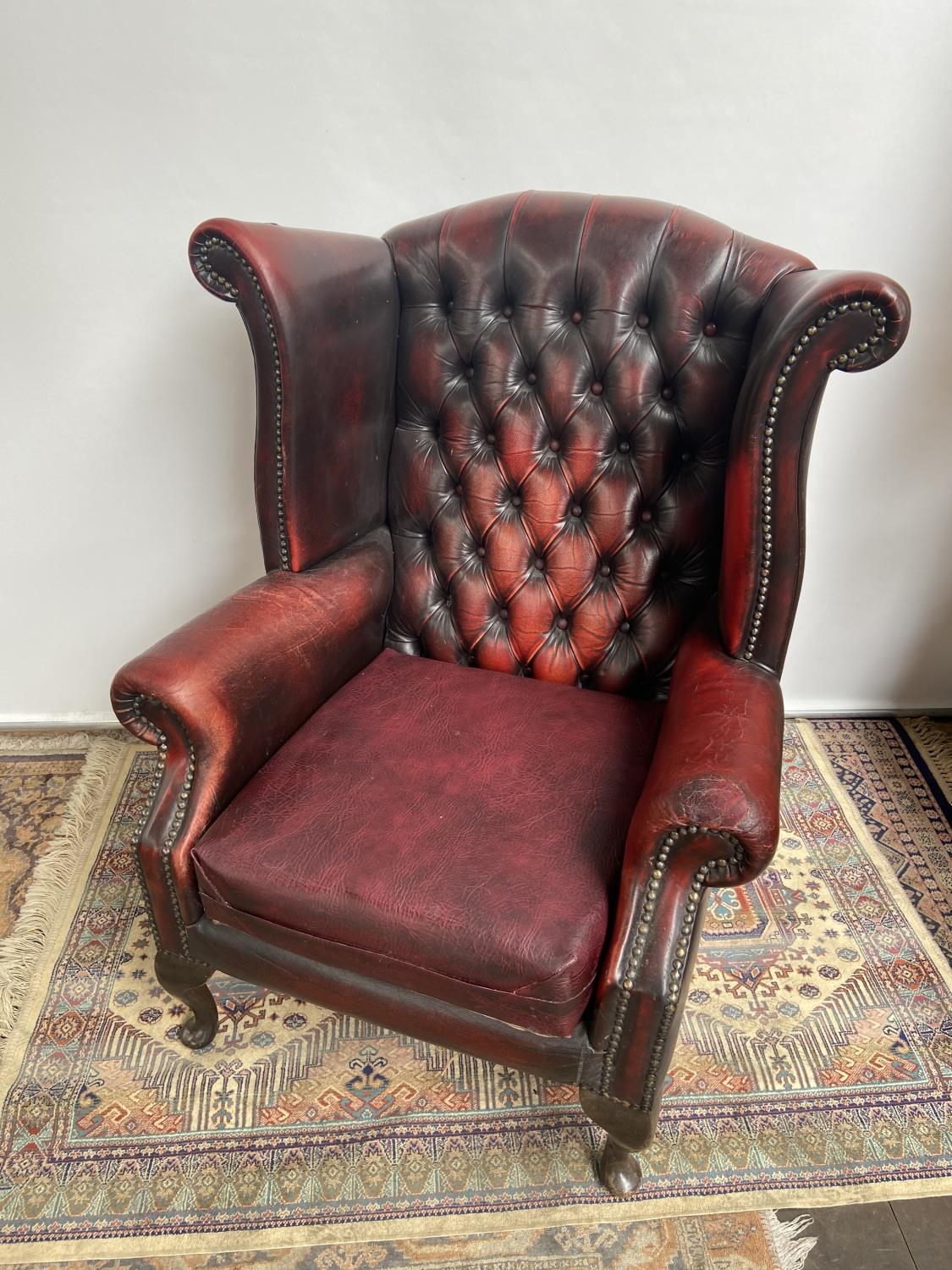 Antique chesterfield oxblood red gull wing arm chair. [107cm in height]