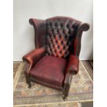 Antique chesterfield oxblood red gull wing arm chair. [107cm in height]