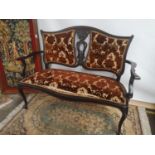 Late 19th/ early 20th century double chairback settee, with a centre carved splat, scroll arms and